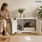A cozy living room scene featuring a woman sitting next to a white Petifo cat litter cabinet with a cat inside, highlighting its stylish home integration.
