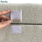  A close-up view of the hook-and-loop velcro attachment tab securing the folded pouffe configuration.