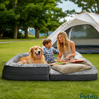 A family enjoying a picnic on a foldable, portable plush pet bed while camping outdoors near a tent.