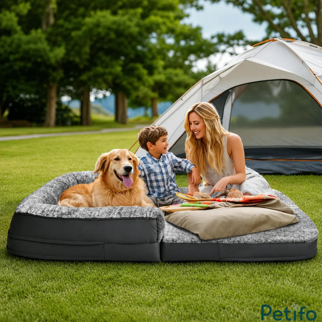 A family enjoying a picnic on a foldable, portable plush pet bed while camping outdoors near a tent.