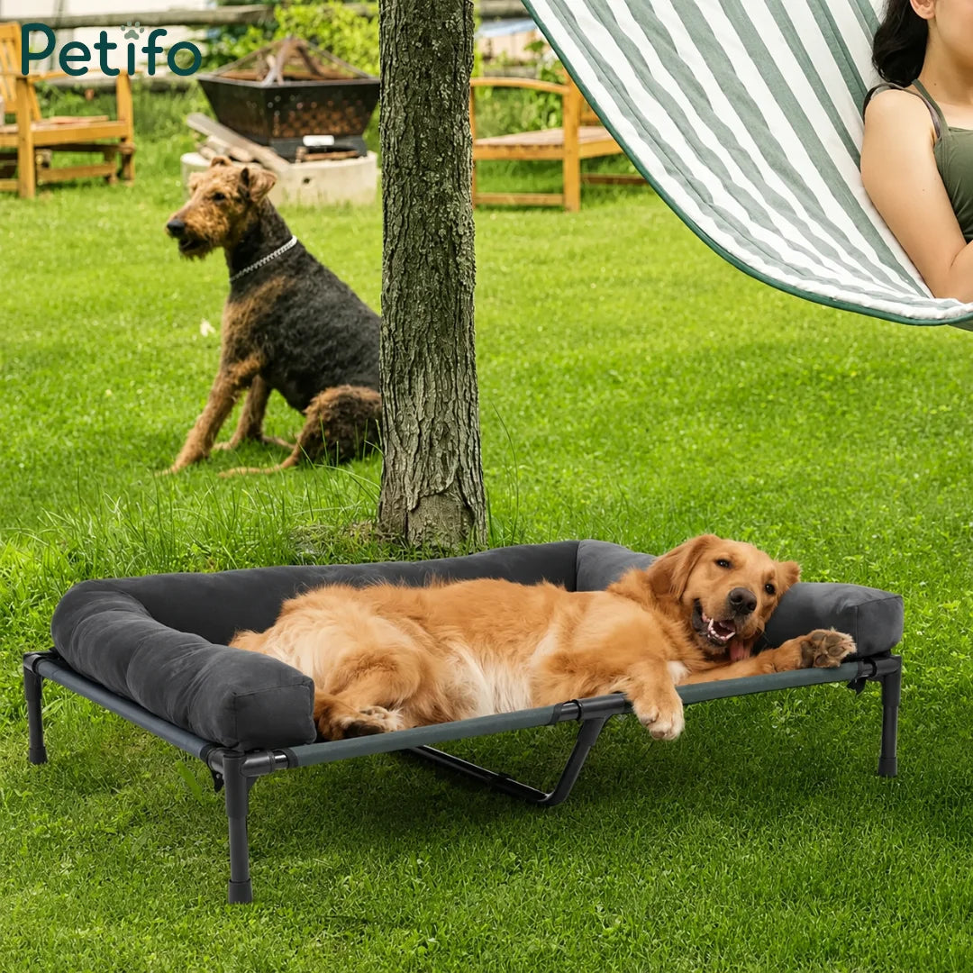 A golden retriever resting comfortably on a Petifo elevated outdoor dog bed in a green garden setting.