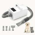 A professional-grade white pet hair dryer with multiple nozzles, shown next to a dog and a cat for size comparison.