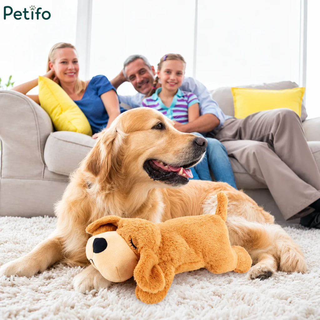 Family relaxing in a living room with a real dog resting next to an anxiety relief plush toy.