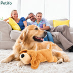 Family relaxing in a living room with a real dog resting next to an anxiety relief plush toy.