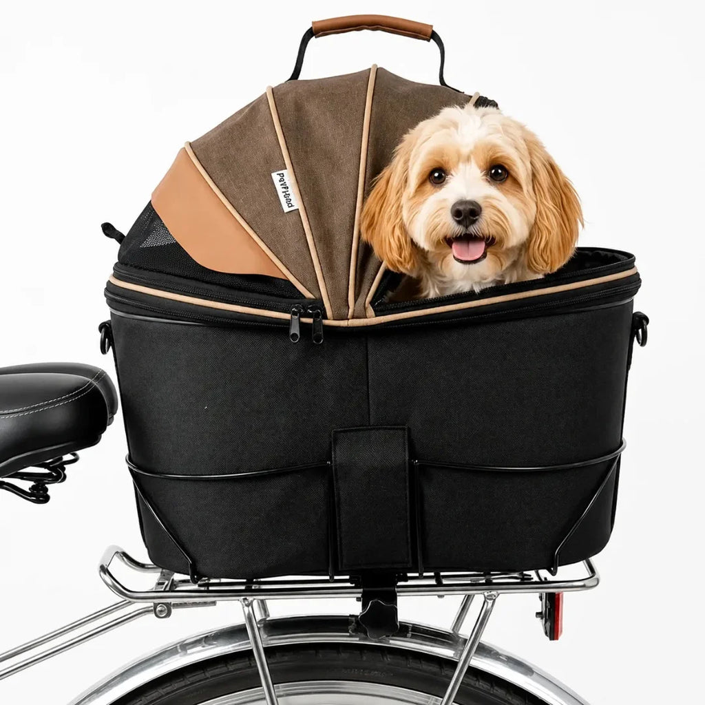 Black and brown bike-mounted pet carrier basket securely attached to a bicycle with a happy small dog looking out.