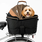 Black and brown bike-mounted pet carrier basket securely attached to a bicycle with a happy small dog looking out.