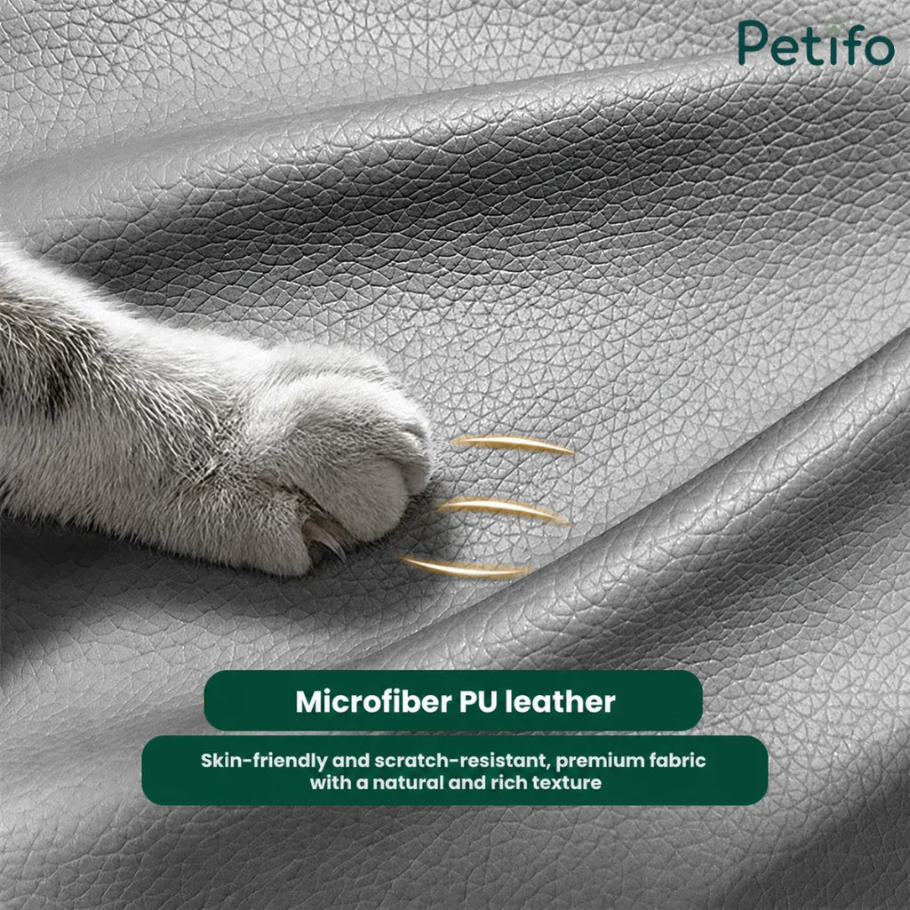 Close-up of a cat's paw touching premium, skin-friendly, and scratch-resistant microfiber PU leather upholstery on a pet sofa.