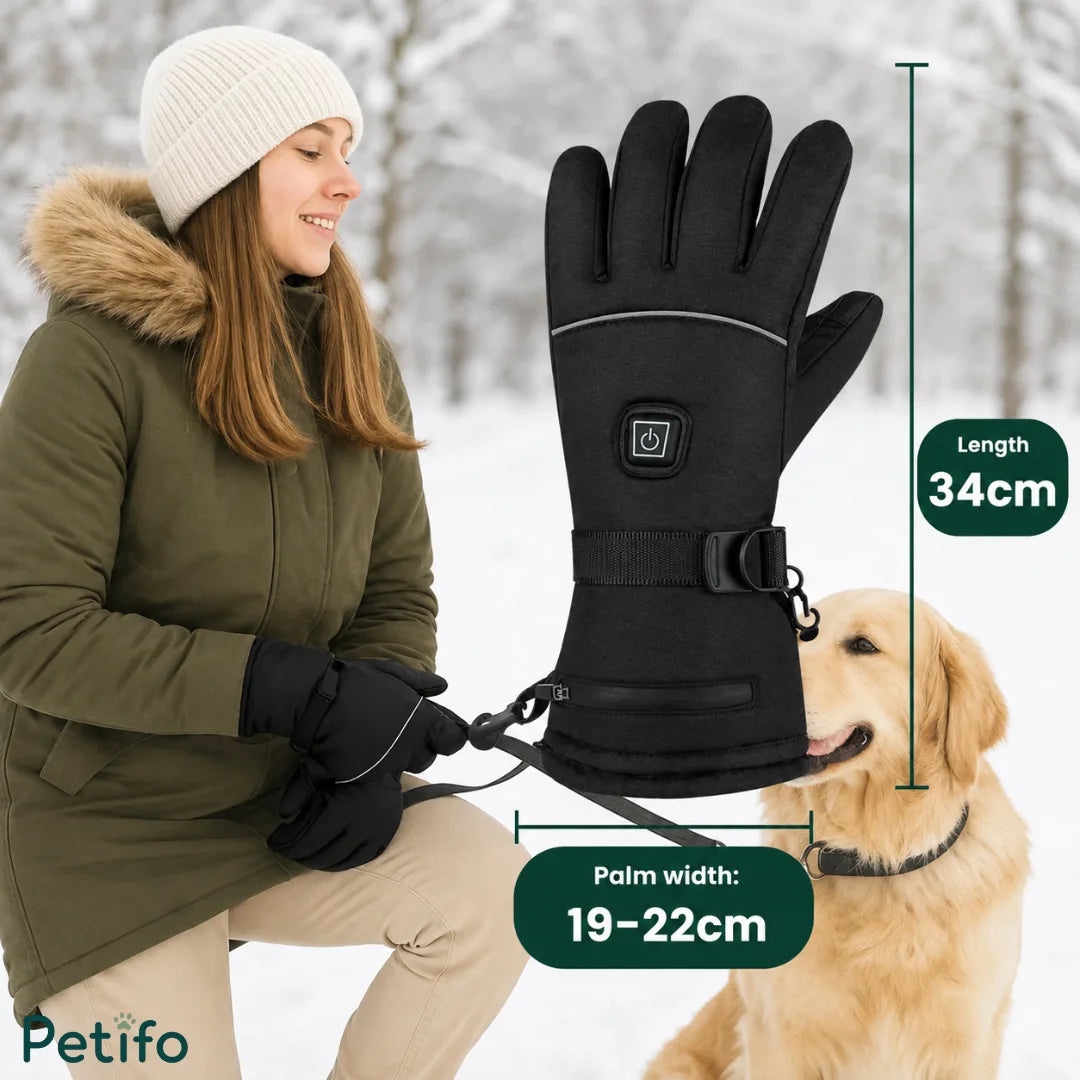 Close-up shot of water splashing heavily against the surface of a black Petifo heated glove, demonstrating its water-resistant capability against rain and snow.