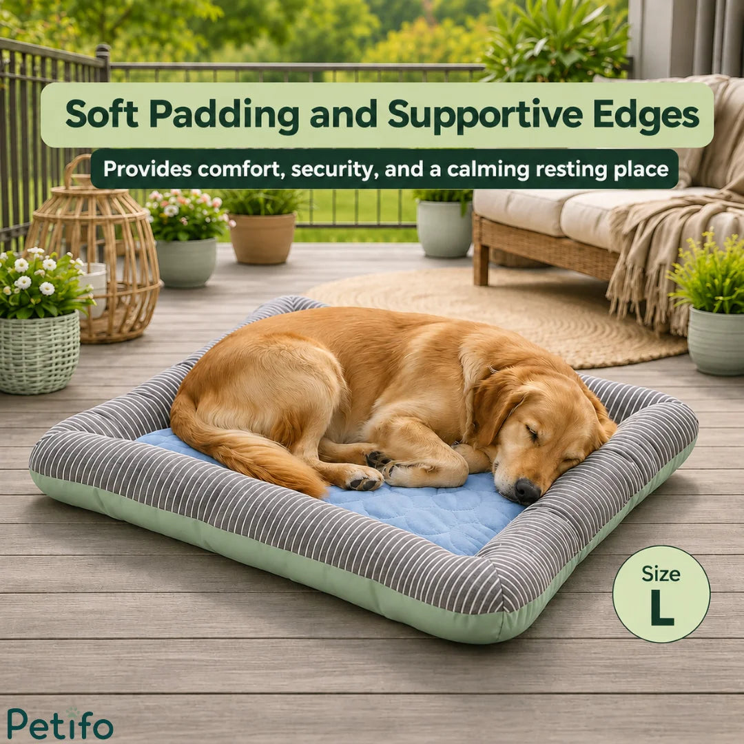 A golden retriever resting comfortably on a large cooling pet bed placed on an outdoor wooden deck.