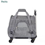 Compact grey pet travel bag with a sturdy top handle and smooth-rolling wheels for easy transport.