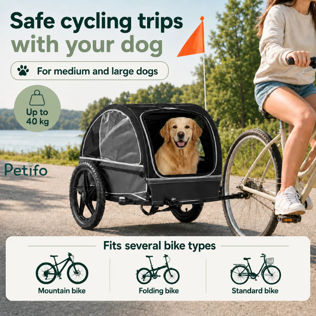 A person cycling outdoors with a black pet trailer that supports medium to large dogs up to 40 kg, compatible with mountain, folding, and standard bikes.