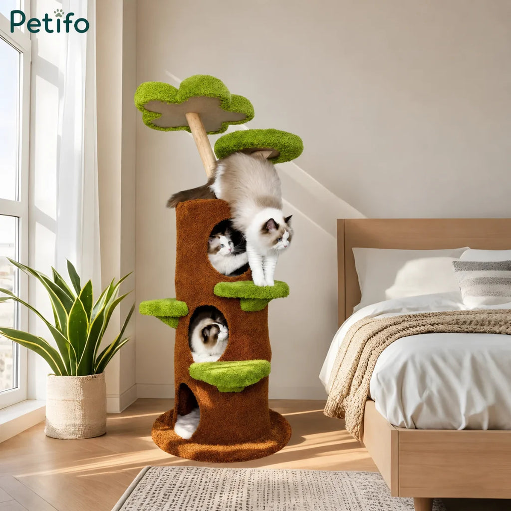 Cozy home interior featuring a tree-shaped cat tower with three cats climbing and resting on different levels.