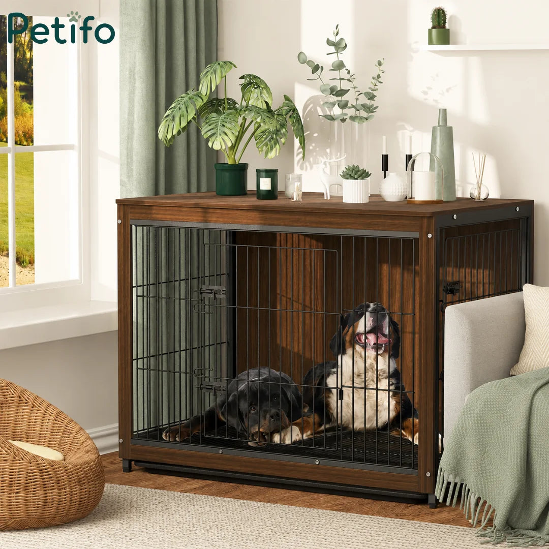 A wooden Petifo dog crate furniture piece with metal bars, housing two dogs in a cozy, stylish living room setting.