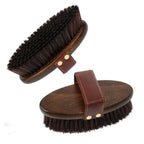 Two wooden horse grooming brushes with dark bristles and leather hand straps shown from different angles.