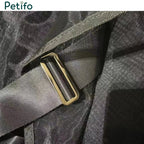 Detail shot of a durable strap and metallic adjustment buckle on a black mesh horse rug.