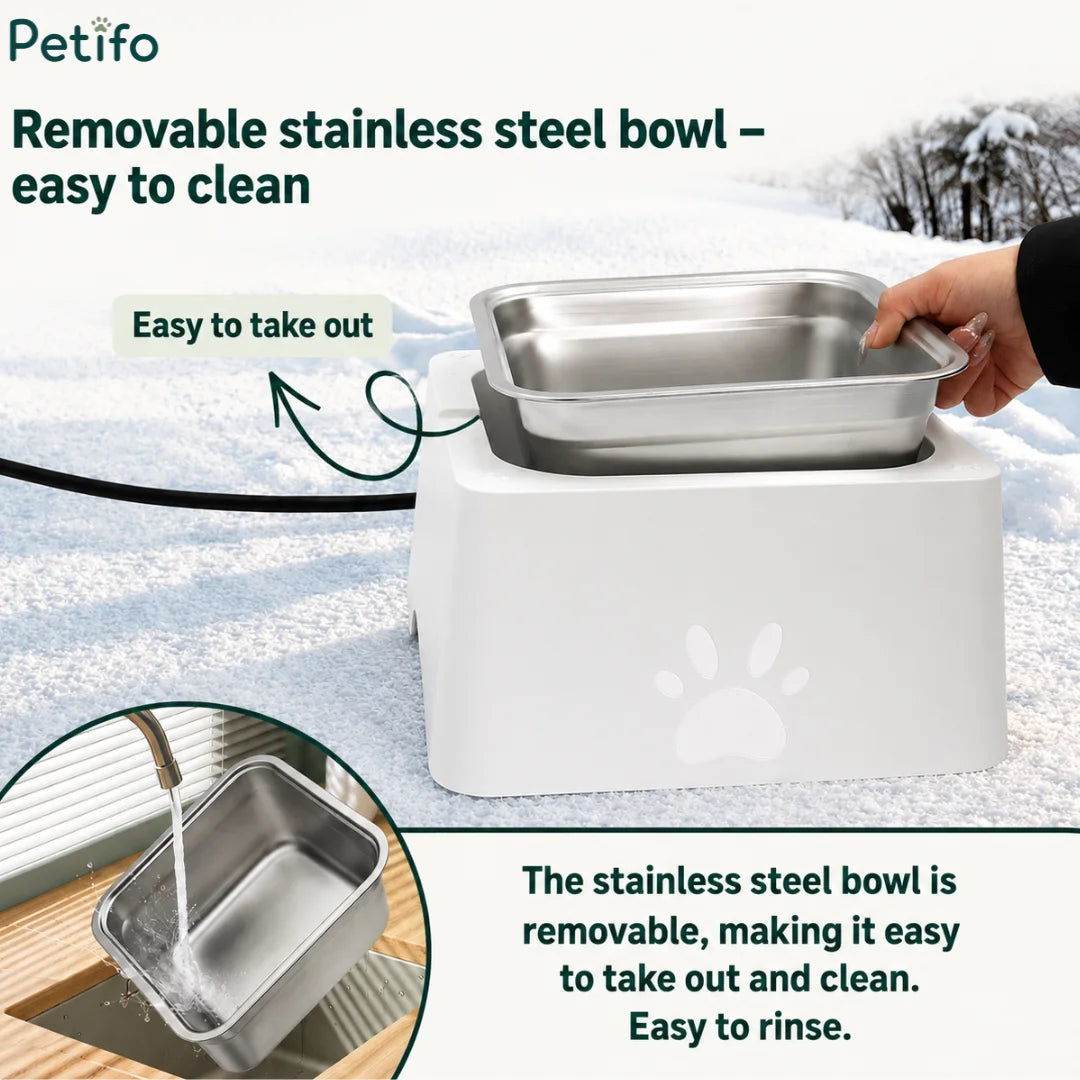 Hand removing the stainless steel insert from the heated pet bowl for easy cleaning and rinsing under a faucet.