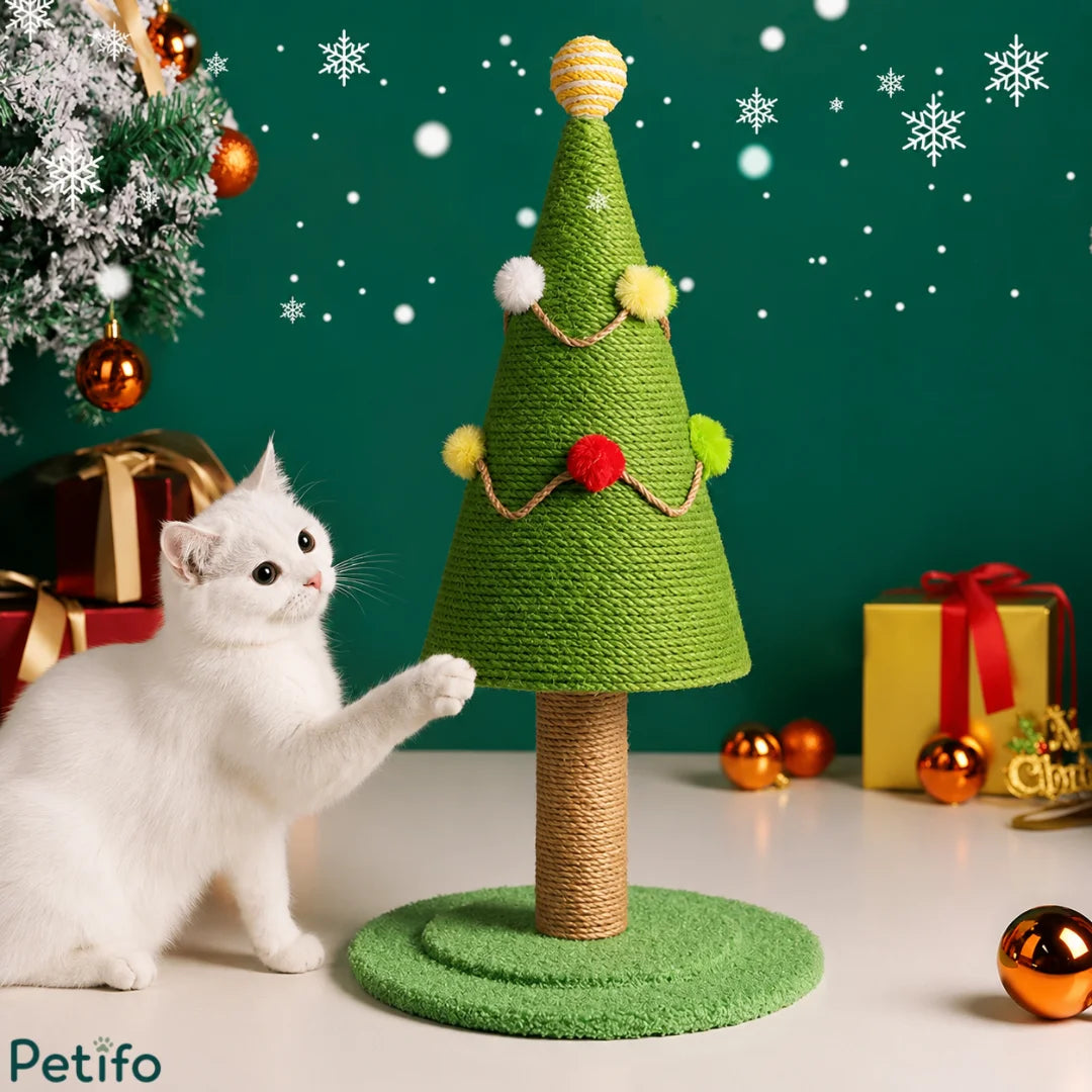 Cute white kitten playing with a festive green Christmas tree cat scratcher surrounded by holiday gifts and snowflakes.