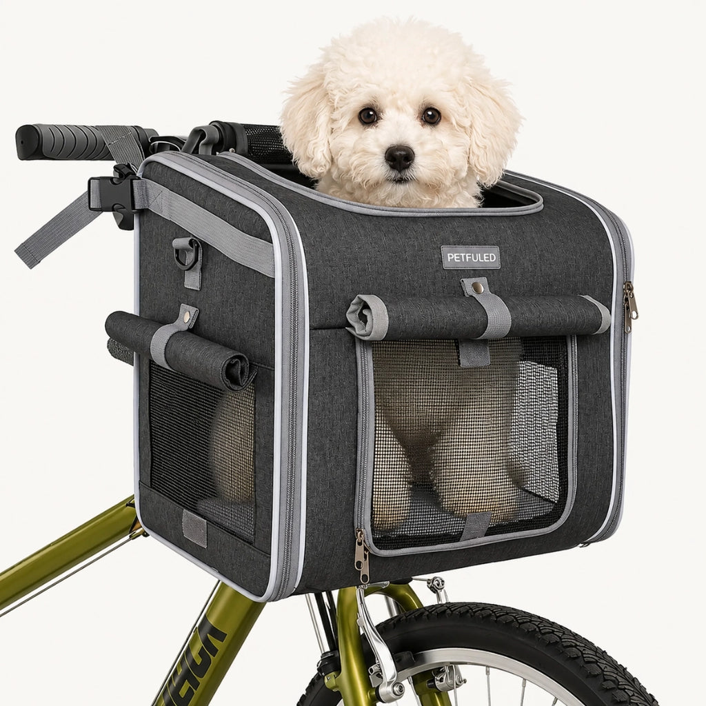 Fluffy white puppy sitting happily inside the Petfuled bicycle pet bag mounted on a green bike.
