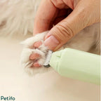 Close-up view of a precision trimmer gently shaving the hair between a dog's paw pads.