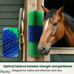 A brown horse standing next to a green and blue wall-mounted scratcher outside a stable.