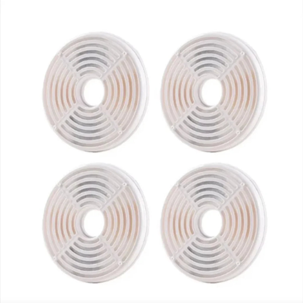 Grid arrangement of four circular replacement water fountain filters for pets.