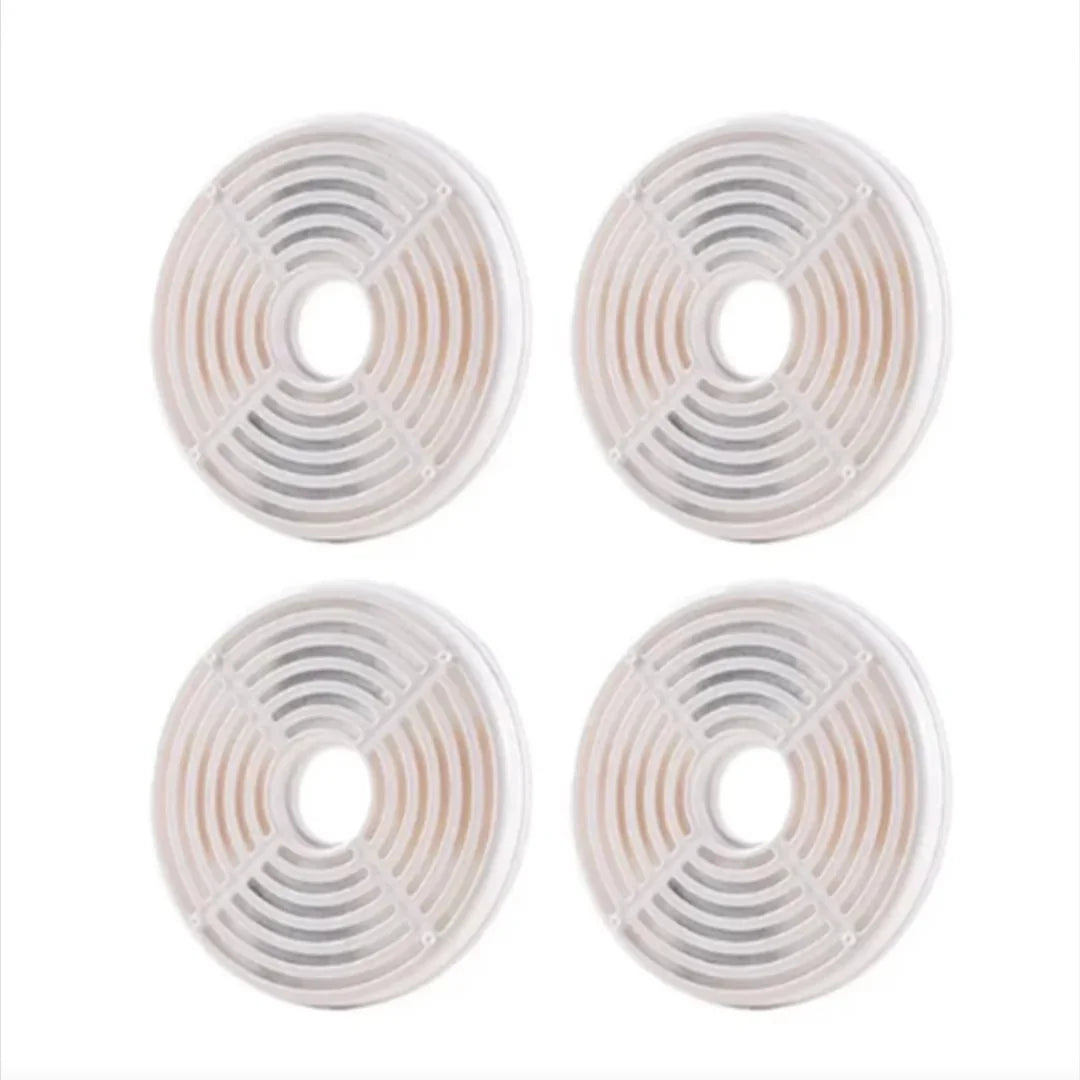 Grid arrangement of four circular replacement water fountain filters for pets.