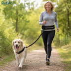 Woman jogging along a park path while walking her golden retriever using a hands-free waist leash.