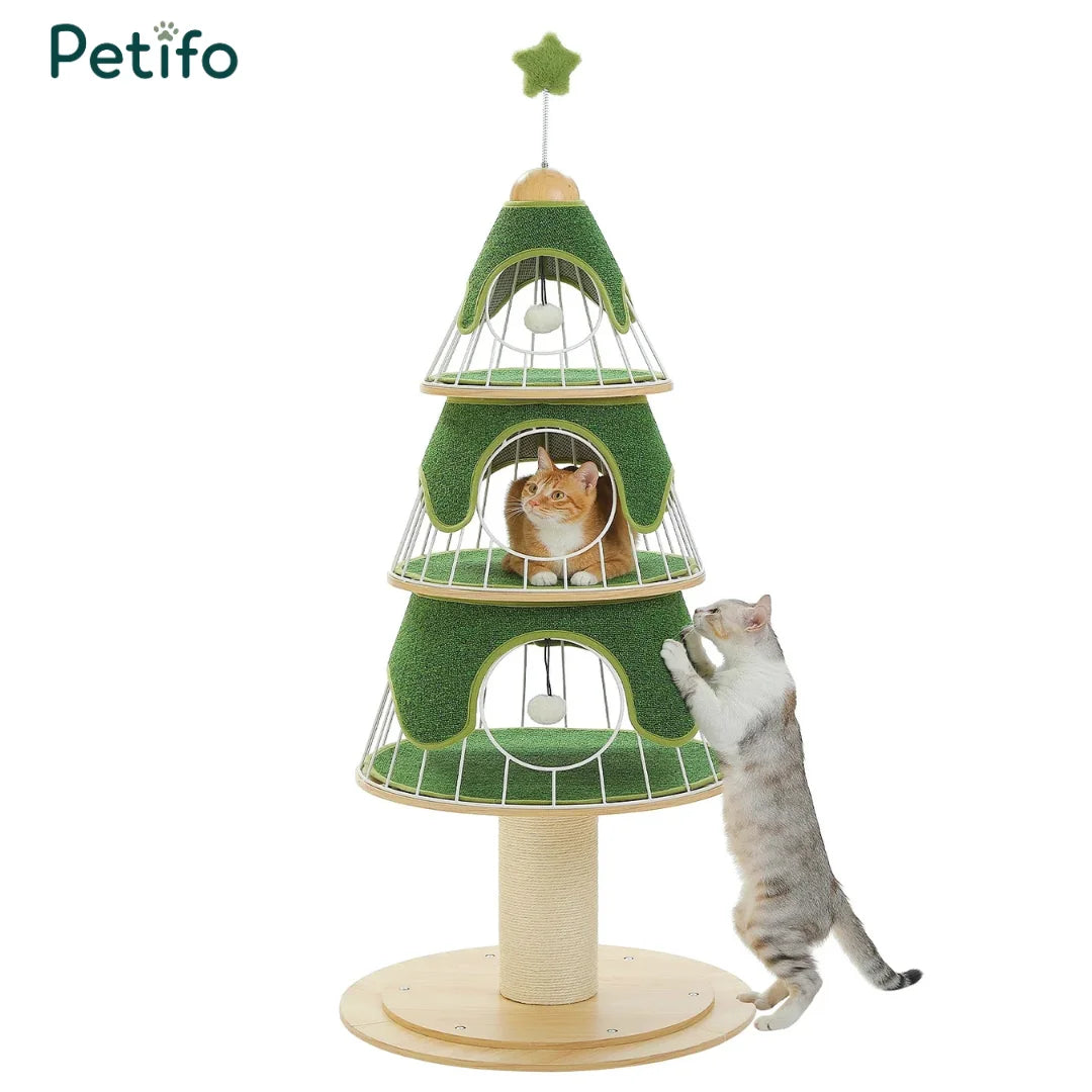 A green, three-tier Christmas tree-themed cat tower featuring hanging play toys and two cats interacting with the structure.