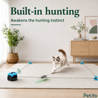 Cat pouncing on a moving teaser toy to awaken hunting instincts with an automatic indoor entertainment device.