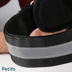 Close-up of a black dog harness strap featuring integrated reflective striping.