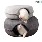 Two stacked felt cat beds in light and dark gray with playful kittens peering out of the openings.