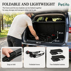 Man loading a compact, folded Petifo pet stroller frame into a car trunk.