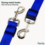 Detailed view of strong metal hooks and strap adjusters for equestrian gear.