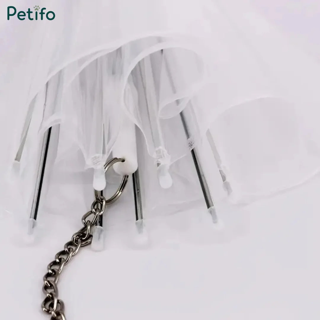 A close-up view of the interior metal ribs and connecting leash hook inside a folded clear pet umbrella.