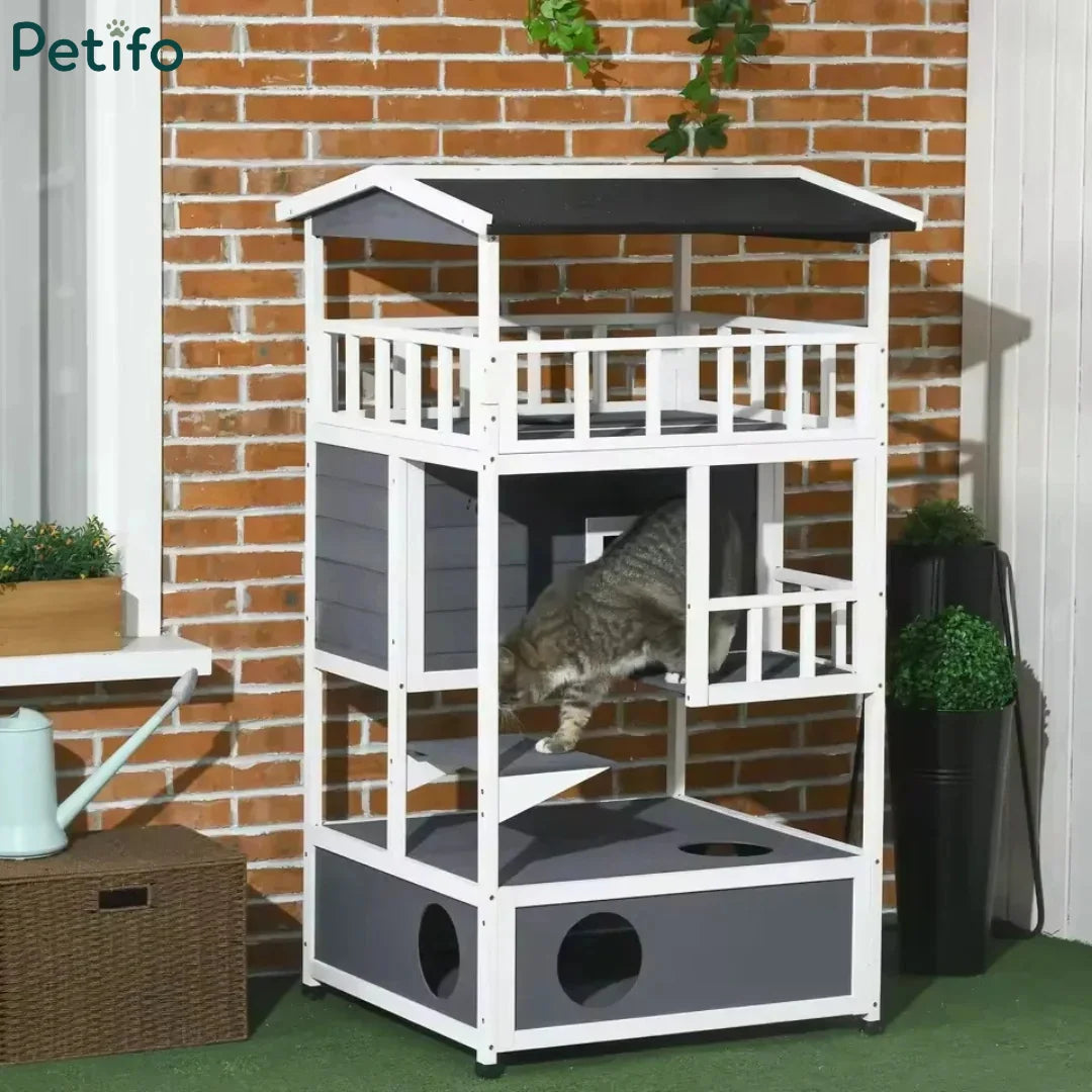 Cat exploring a multi-level wooden outdoor cat enclosure set against a brick wall.