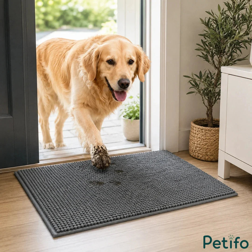 Golden Retriever with muddy paws stepping through a doorway onto a non-slip absorbent door mat.