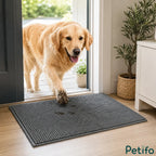 Golden Retriever with muddy paws stepping through a doorway onto a non-slip absorbent door mat.