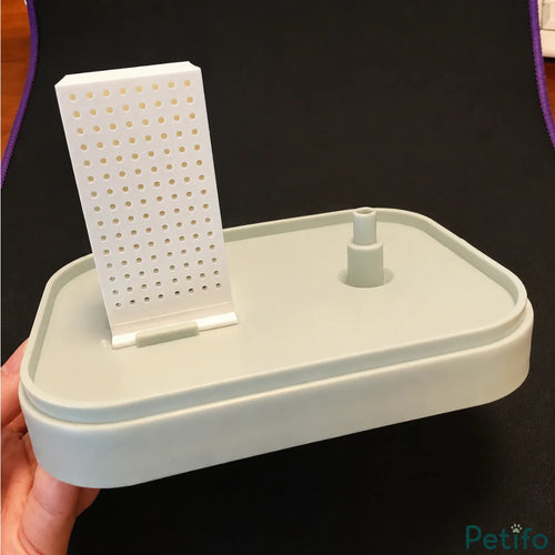 Assembled plastic water fountain base with a filter cartridge inserted