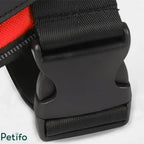Macro view of a durable black plastic quick-release buckle on a pet harness.