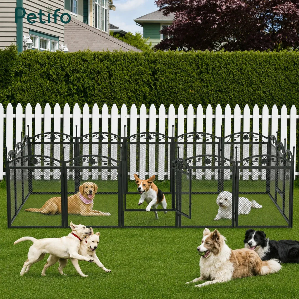 Several happy dogs playing and relaxing within a large, fenced-in area created by the Petifo modular dog playpen on a grassy lawn.