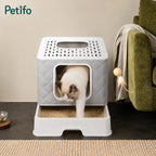 A cat exiting a Petifo top-entry litter box in a cozy living room, showcasing the removable tray design.