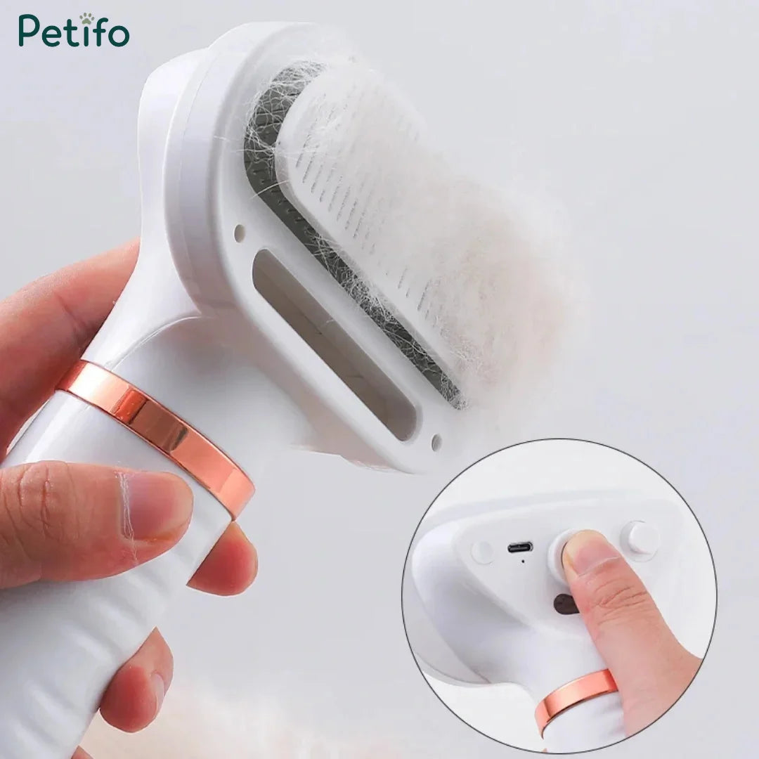 Close-up of a hand holding the white and rose-gold grooming brush with a layer of collected pet fur on the bristles, alongside an inset showing a finger pressing the control button.