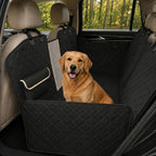 A black car dog seat protector installed in the back seat of a vehicle with a golden retriever sitting comfortably.