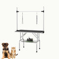 Sturdy foldable pet grooming table with a non-slip surface and accessory storage shelf.