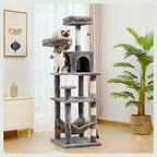 This image displays the 161 cm tall grey cat tree in a bright living space, showcasing its various platforms and the lower hammock.
