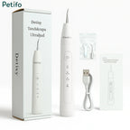 Unboxing layout displaying the Petifo Detixy Ultrasonic Dental Scaler device alongside its product box, replacement cleaning tips, a tightening tool, a USB charging cable, and an instruction manual.