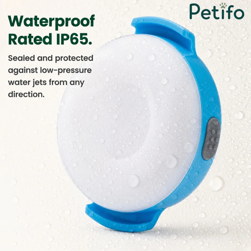 Waterproof IP65 rated Petifo LED dog safety light covered in water droplets.
