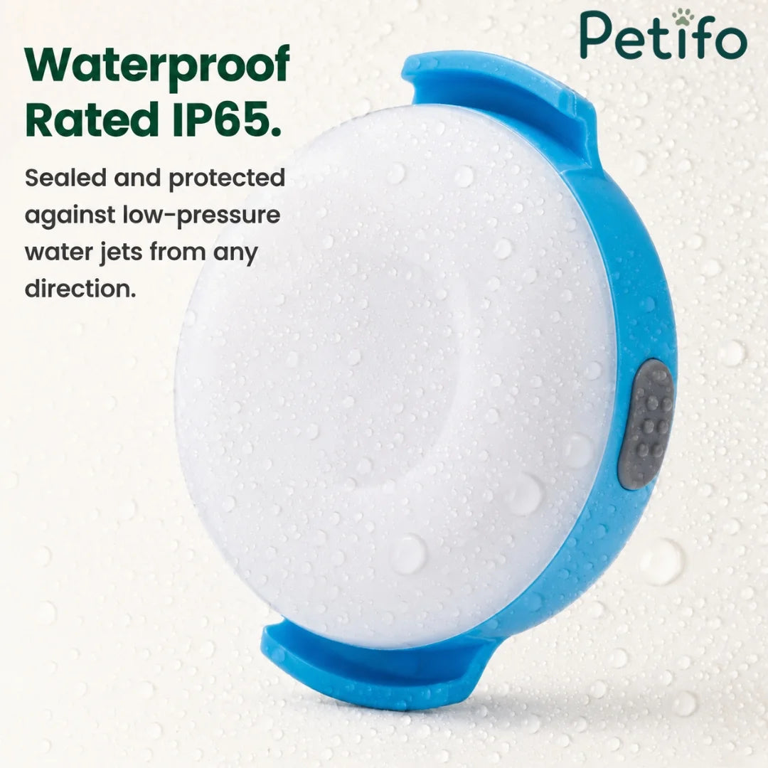 Waterproof IP65 rated Petifo LED dog safety light covered in water droplets.