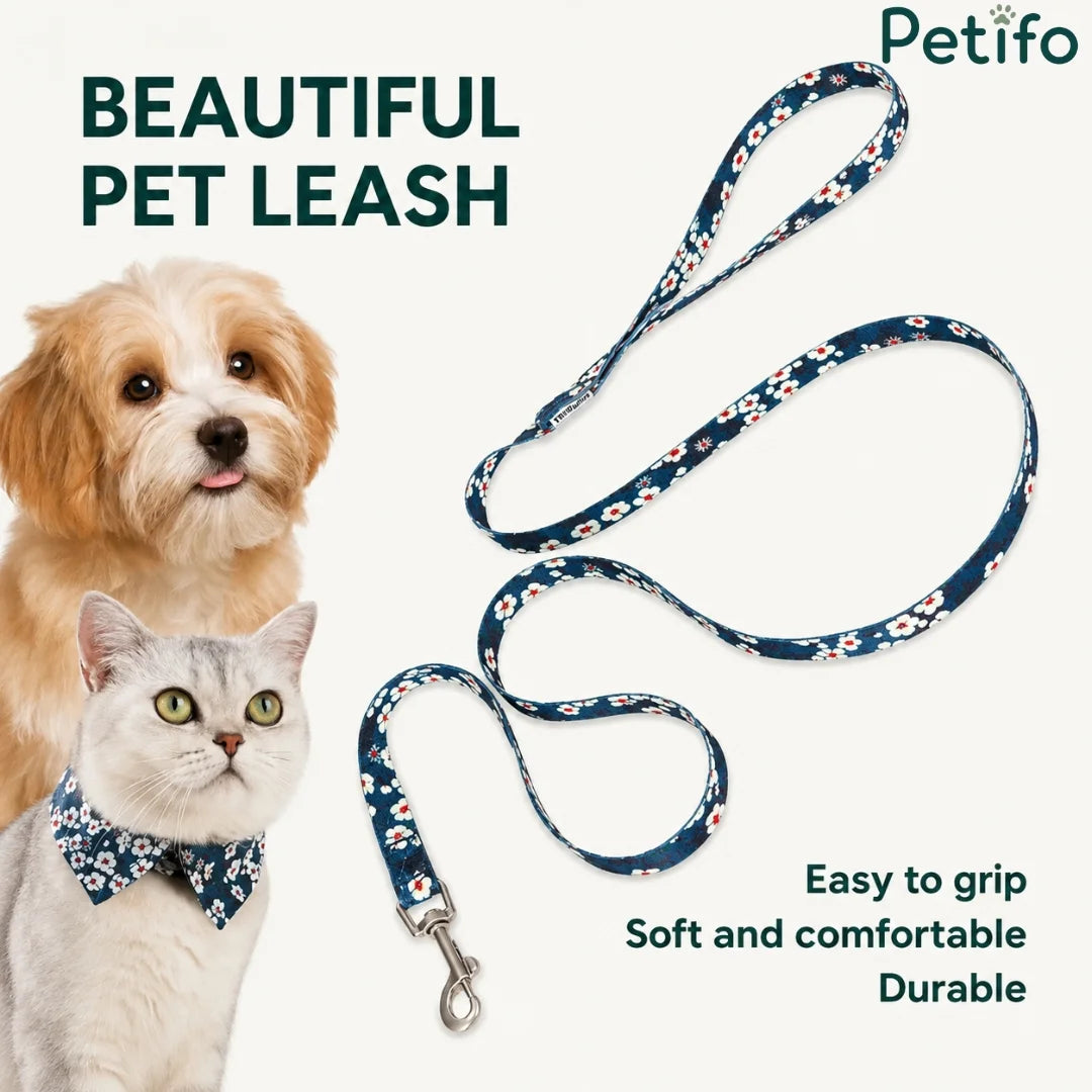 floral pet leash displayed next to a fluffy dog and a cat wearing a matching bow tie.