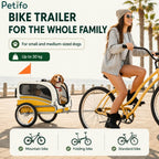 Woman riding bicycle pulling a Petifo dog bike trailer.